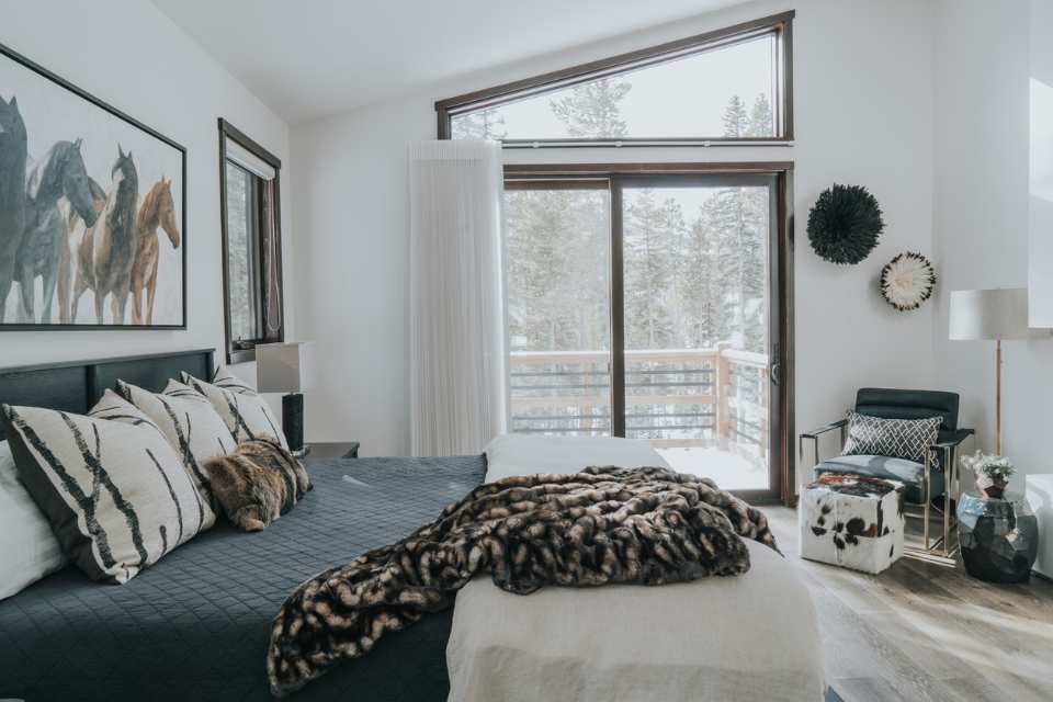 cozy layers in ski chalet bedroom with artwork above bed